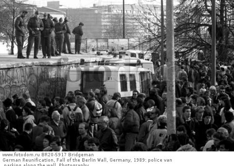 German Reunification, Fall of the Berlin Wall, Germany, 1989: police van parking along the wall. Photography