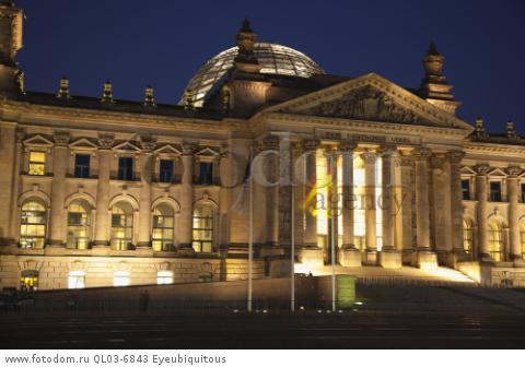 Germany, Berlin, Mitte, Reichstag building with glass dome deisgned by Norman Foster, illuminated at night.