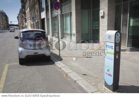 Germany, Berlin, Mitte, Citroen electric car being charged at roadside point.