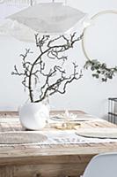 Gnarled branch and DIY decorations on table