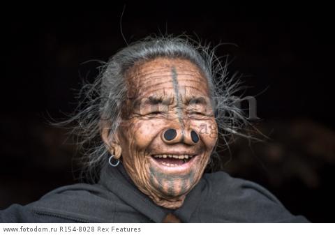 Mandatory Credit: Photo by Solent News/REX Shutterstock (4909075b)
One of the Apatani women with her facial tattoo and nose plugs
Apatani tribal women, Arunachal Pradesh, India - Apr 2015
*Full story: http://www.rexfeatures.com/nanolink/qoi2
A photographer was given unique access to incredible tribal women who each have the same facial tattoo and nose plugs. Cezary Wyszynski, 38, stayed with the Apatani people in India whose women all went through the dramatic face-changing ritual when they had their first period. A guide took Cezary through their villages in the Ziro Valley in Arunachal Pradesh, India, where the last known 'plugging and tattooing' happened in 1972. The ancient tradition no longer takes place but women aged over 50 still display their remarkable wooden nose plugs - while others have removed them and had plastic surgery afterwards. The reason the younger women do not have the same distinctive features is because when they mixed with people from other cultures people declined to mix because they looked so unusual.