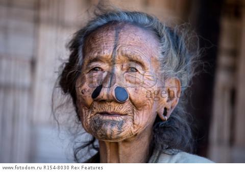 Mandatory Credit: Photo by Solent News/REX Shutterstock (4909075g)
One of the Apatani women with her facial tattoo and nose plugs
Apatani tribal women, Arunachal Pradesh, India - Apr 2015
*Full story: http://www.rexfeatures.com/nanolink/qoi2
A photographer was given unique access to incredible tribal women who each have the same facial tattoo and nose plugs. Cezary Wyszynski, 38, stayed with the Apatani people in India whose women all went through the dramatic face-changing ritual when they had their first period. A guide took Cezary through their villages in the Ziro Valley in Arunachal Pradesh, India, where the last known 'plugging and tattooing' happened in 1972. The ancient tradition no longer takes place but women aged over 50 still display their remarkable wooden nose plugs - while others have removed them and had plastic surgery afterwards. The reason the younger women do not have the same distinctive features is because when they mixed with people from other cultures people declined to mix because they looked so unusual.