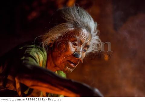 Mandatory Credit: Photo by Solent News/REX Shutterstock (4909075o)
One of the Apatani women with her facial tattoo and nose plugs
Apatani tribal women, Arunachal Pradesh, India - Apr 2015
*Full story: http://www.rexfeatures.com/nanolink/qoi2
A photographer was given unique access to incredible tribal women who each have the same facial tattoo and nose plugs. Cezary Wyszynski, 38, stayed with the Apatani people in India whose women all went through the dramatic face-changing ritual when they had their first period. A guide took Cezary through their villages in the Ziro Valley in Arunachal Pradesh, India, where the last known 'plugging and tattooing' happened in 1972. The ancient tradition no longer takes place but women aged over 50 still display their remarkable wooden nose plugs - while others have removed them and had plastic surgery afterwards. The reason the younger women do not have the same distinctive features is because when they mixed with people from other cultures people declined to mix because they looked so unusual.