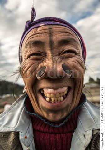 Mandatory Credit: Photo by Solent News/REX Shutterstock (4909075a)
One of the Apatani women with her facial tattoo and nose plugs
Apatani tribal women, Arunachal Pradesh, India - Apr 2015
*Full story: http://www.rexfeatures.com/nanolink/qoi2
A photographer was given unique access to incredible tribal women who each have the same facial tattoo and nose plugs. Cezary Wyszynski, 38, stayed with the Apatani people in India whose women all went through the dramatic face-changing ritual when they had their first period. A guide took Cezary through their villages in the Ziro Valley in Arunachal Pradesh, India, where the last known 'plugging and tattooing' happened in 1972. The ancient tradition no longer takes place but women aged over 50 still display their remarkable wooden nose plugs - while others have removed them and had plastic surgery afterwards. The reason the younger women do not have the same distinctive features is because when they mixed with people from other cultures people declined to mix because they looked so unusual.