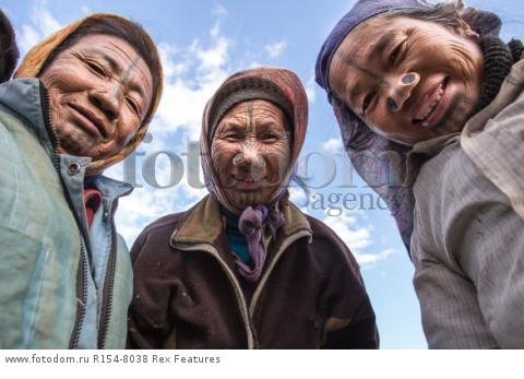 Mandatory Credit: Photo by Solent News/REX Shutterstock (4909075e)
Some of the Apatani women with their facial tattoo and nose plugs
Apatani tribal women, Arunachal Pradesh, India - Apr 2015
*Full story: http://www.rexfeatures.com/nanolink/qoi2
A photographer was given unique access to incredible tribal women who each have the same facial tattoo and nose plugs. Cezary Wyszynski, 38, stayed with the Apatani people in India whose women all went through the dramatic face-changing ritual when they had their first period. A guide took Cezary through their villages in the Ziro Valley in Arunachal Pradesh, India, where the last known 'plugging and tattooing' happened in 1972. The ancient tradition no longer takes place but women aged over 50 still display their remarkable wooden nose plugs - while others have removed them and had plastic surgery afterwards. The reason the younger women do not have the same distinctive features is because when they mixed with people from other cultures people declined to mix because they looked so unusual.