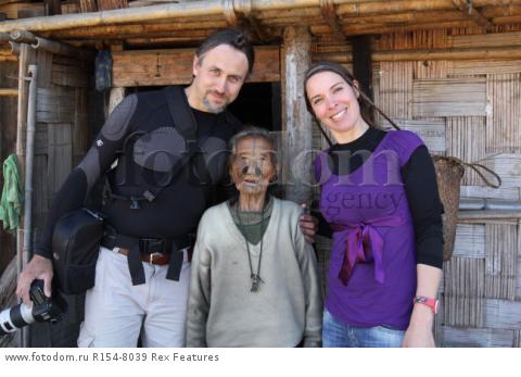 Mandatory Credit: Photo by Solent News/REX Shutterstock (4909075q)
Photographer Cezary Wyszynski with his wife Desiree van Thiel posing with one of the Apatani women with her facial tattoo and nose plugs
Apatani tribal women, Arunachal Pradesh, India - Apr 2015
*Full story: http://www.rexfeatures.com/nanolink/qoi2
A photographer was given unique access to incredible tribal women who each have the same facial tattoo and nose plugs. Cezary Wyszynski, 38, stayed with the Apatani people in India whose women all went through the dramatic face-changing ritual when they had their first period. A guide took Cezary through their villages in the Ziro Valley in Arunachal Pradesh, India, where the last known 'plugging and tattooing' happened in 1972. The ancient tradition no longer takes place but women aged over 50 still display their remarkable wooden nose plugs - while others have removed them and had plastic surgery afterwards. The reason the younger women do not have the same distinctive features is because when they mixed with people from other cultures people declined to mix because they looked so unusual.