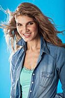 A young brunette woman wearing a denim shirt and a