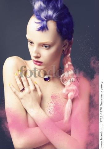 A young woman with a purple and pale pink hair piece and a dusting of pink powder